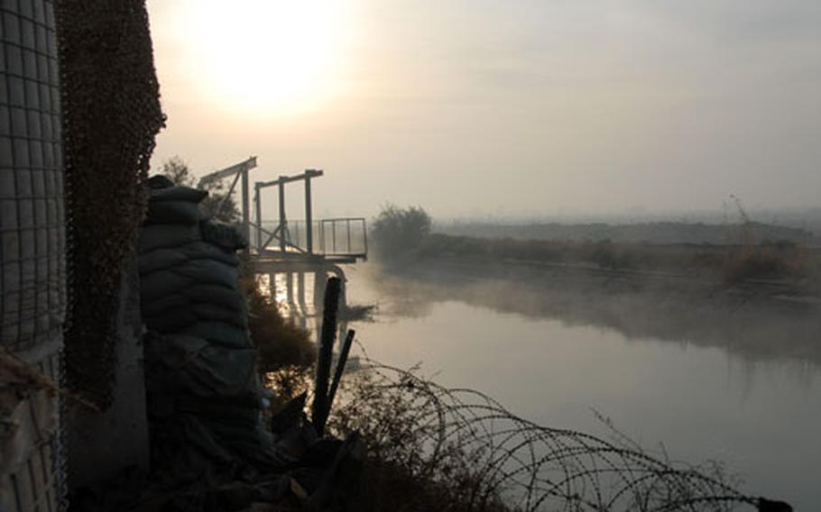 Early-morning fog hangs over the water pump house near Fallujah, Iraq. Ninth Engineer Support Battalion Marines have fortified the pump house compound to protect it from attacks by insurgents, who often pull up on the other side of the canal and launch grenades at the facility.