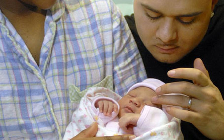 Spc. Angie-Lee Korkmaz, a soldier assigned to the 212th Combat Support Hospital, enjoys a moment with her new daughter, Jayla Amore, and her husband Erkan at Landstuhl Regional Medical Center Monday.