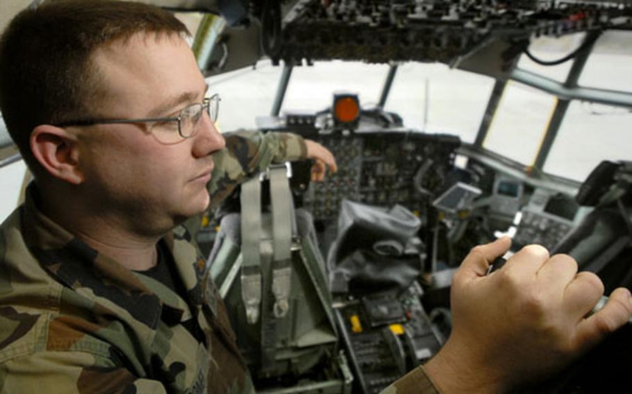 Staff Sgt. Benjamin Comer looks around the flight deck of his aircraft during a media tour Wednesday, the day before it retires from active duty at Ramstein Air Base.