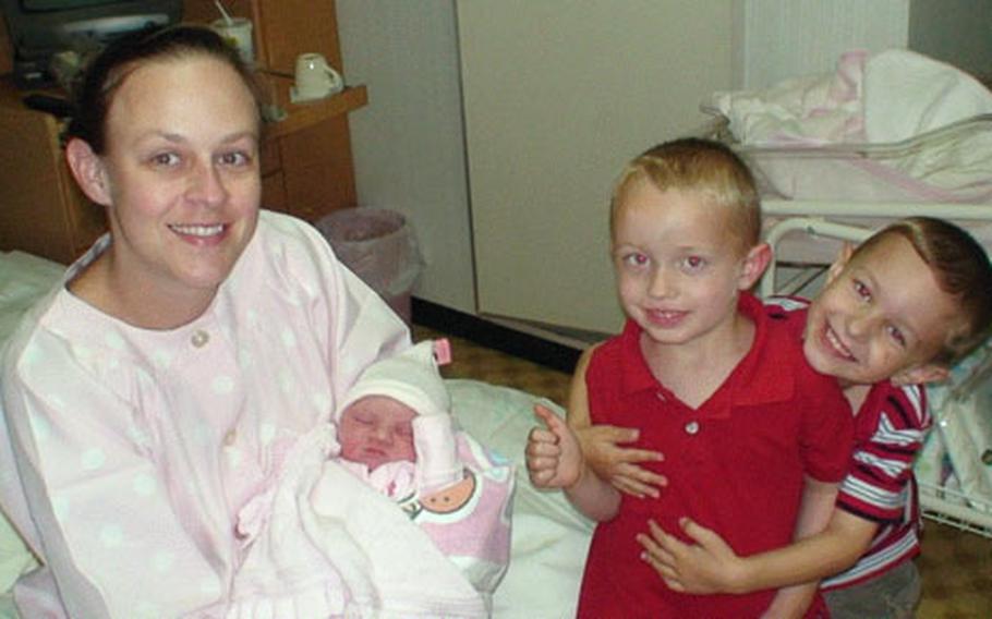 Jennifer Toth holds baby Shiann on the day she was born, Nov. 1, at Iwakuni Byoin. Also pictured are Shiann’s big brothers, Jacob, left, and Jenson, right.