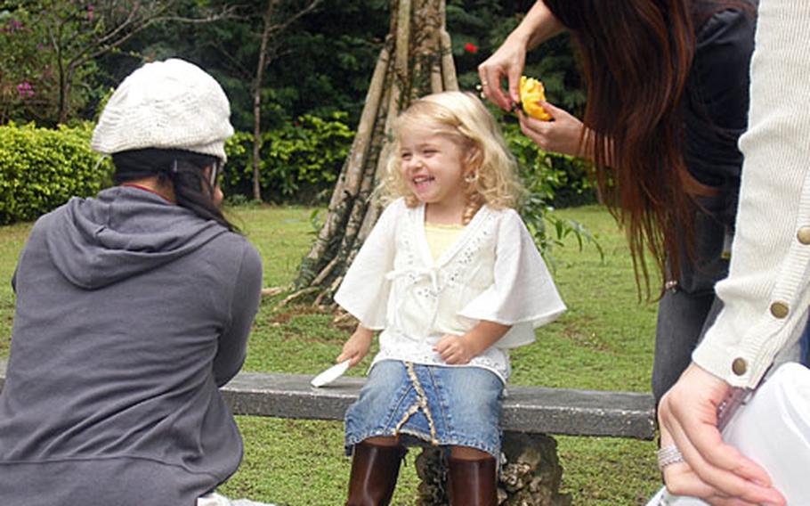 Stylists put on the final touches on Odessa Fredericks&#39; outfit at a modeling shoot Friday in the Southeastern Botanical Gardens.