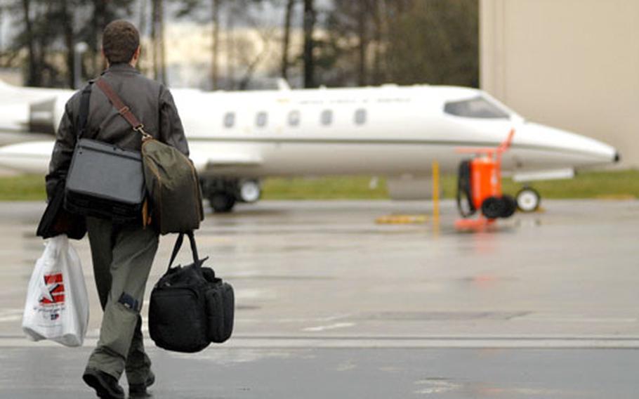 Capt. Matt Dudderar, a pilot assigned to the 76th Airlift Squadron, walks to a C-21 bound for the Aerospace Maintenance and Regeneration Center at Davis-Monthan Air Force Base, Ariz., on Monday.