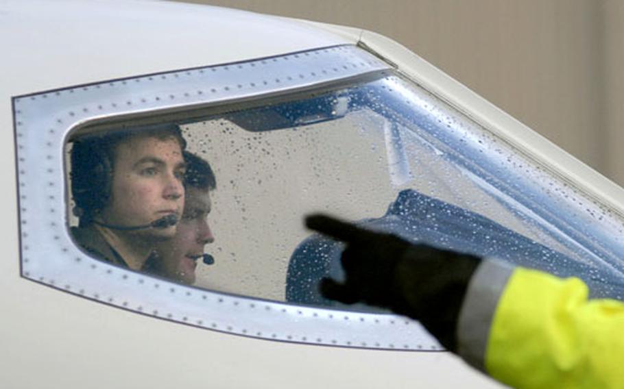 Capt. Matt Dudderar, a pilot assigned to the 76th Airlift Squadron, looks out from the cockpit of a C-21 that is on its way to Arizona.