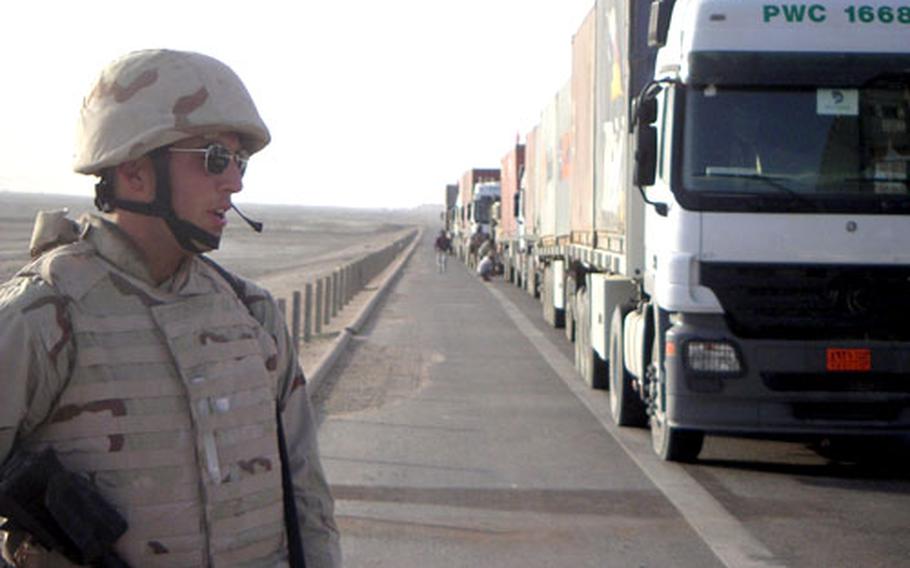 Airman 1st Class Trevor Veitz, a vehicle operator with the 35th Logistics Readiness Squadron at Misawa Air Base, Japan, stands roadside during convoy duty last year in Iraq.