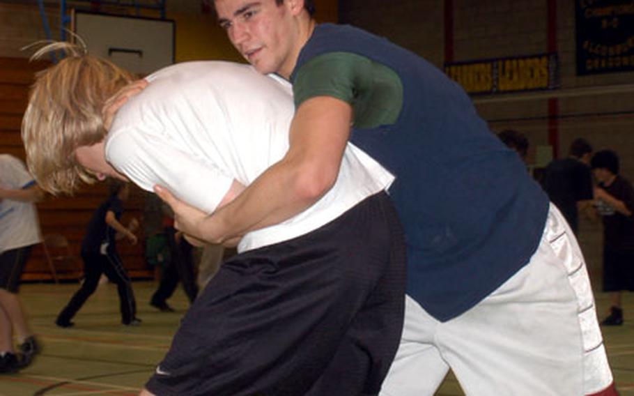 Alconbury senior Luis Trujillo (blue shirt) practices moves with senior Bradley Yates last week.