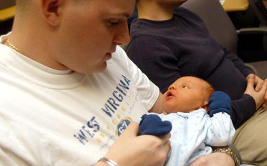 Seaman Thomas Hartman got to attend Boot Camp for New Dads with his son Andrew, as the baby arrived two weeks earlier than planned. Hartman allowed Andrew to be a prop in getting new dads used to baby-handling.