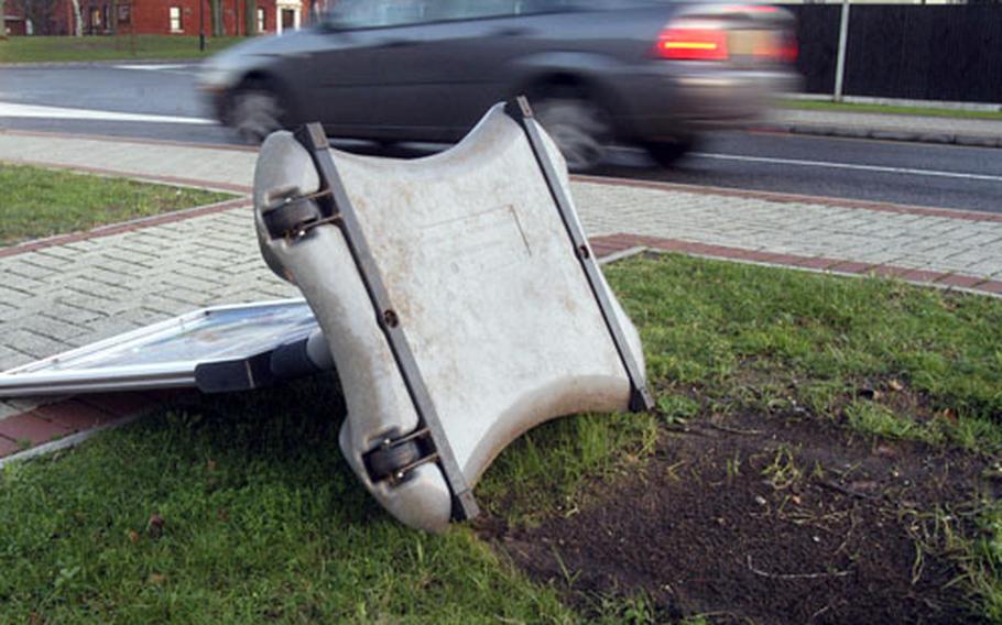 A vehicle passes an advertising sign that was knocked down by strong winds on RAF Mildenhall on Thursday.