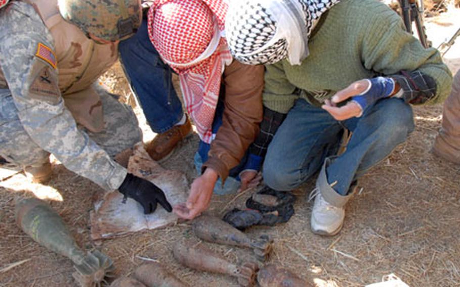An Iraqi translator working for the Army and Iraqi policemen read a ragged, water-damaged insurgent notebook found stashed with a weapons cache during an Iraqi police patrol in Albu Faraj. The notebook contains an inventory list, positions for roadside bomb emplacement and names of insurgents. About 10 mortars along with TNT in plastic bags with a detonator cord and boxes of ammunition were found in the cache.