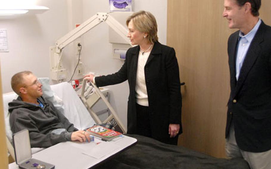 Senators Hillary Rodham Clinton (D-NY) and Evan Bayh (D-IN) visit with Army Sgt. Kenneth Gibson, 26, at the Landstuhl Regional Medical Center Monday. Gibson, a military policeman assigned to the 127th Military Police Company in Hanau, was wounded while deployed to Iraq.