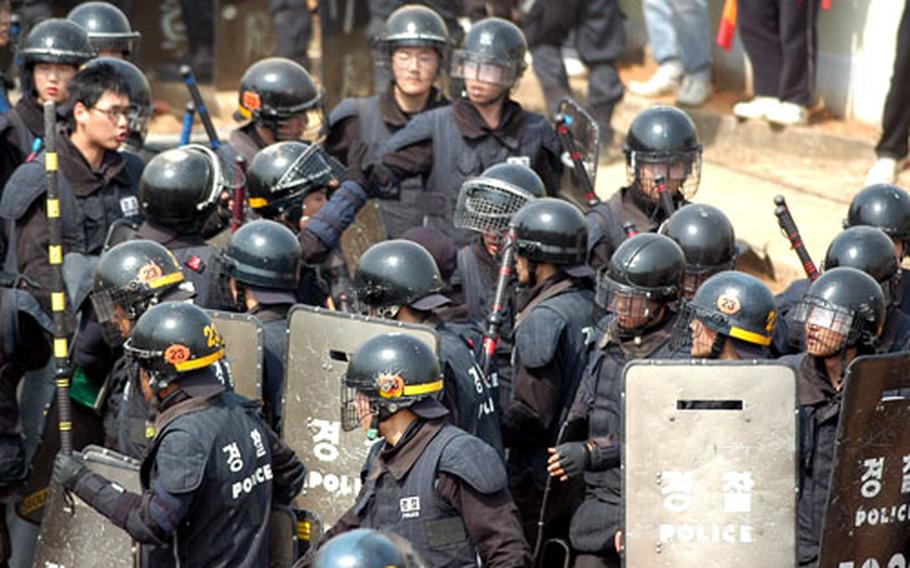 In Daechu-ri village just outside Camp Humphreys, South Korea, on May 4, 2006, riot-equipped Korean National Police officers prepare for a fresh clash with anti-U.S. protesters.
