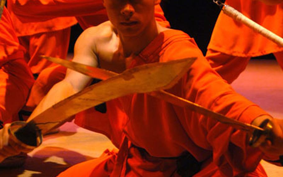 Swordsmen from the Chinese State Circus&#39;s troupe of Shaolin Wu-Shu warriors pose recently at the Cambridge Corn Exchange, where the group was preparing for a series of shows.