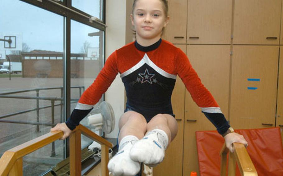 Ten-year-old Rachel Pagio suspends herself in a pike position at the Alconbury Elementary School.