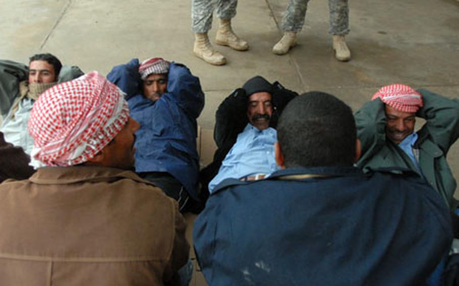 Iraqi police recruits do sit-ups, which is part of the physical fitness test required to become part of the police force.