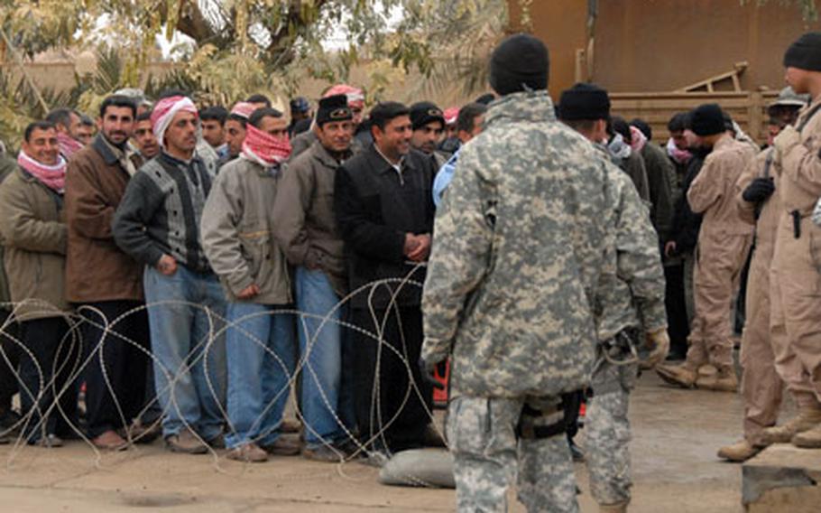 Police recruits wait in line to be screened at Camp Blue Diamond. Qualified applicants were then sent to training in Jordan.