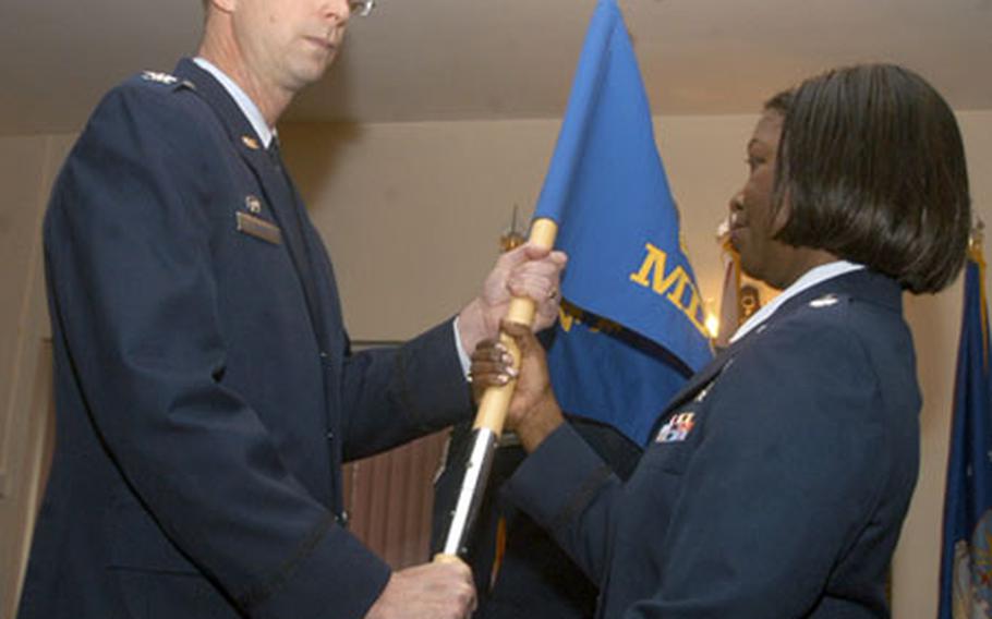 Col. Jack L. Jones, left, 423rd Air Base Group commander, passes the 423rd Medical Squadron guidon to Lt. Col. Hildegarde Stewart, who became the first commander of the newly activated squadron at RAF Alconbury, England.