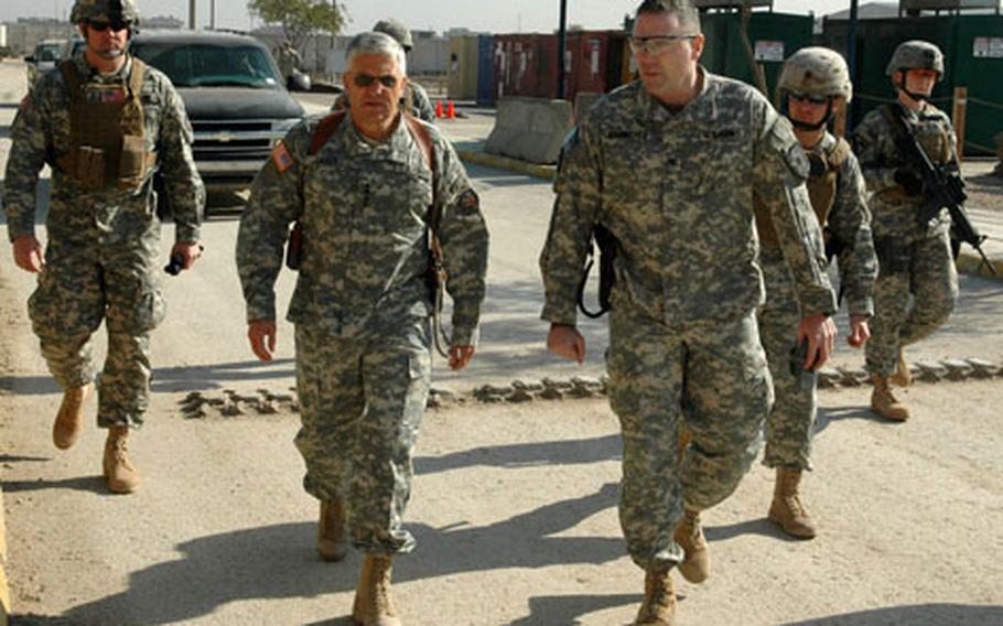 Army Gen. George Casey, commander of Multi-National Force – Iraq, walks to the tactical operations center with Col. Jeffrey Bannister, right, commander of the 2nd Infantry Division’s 2nd Brigade Combat Team at Forward Operating Base Loyalty in Baghdad on Wednesday.