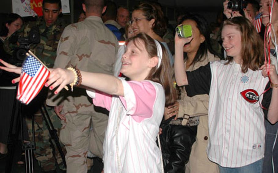Madalyn, left, and Azriel Royse prepare to greet their father, Senior Airman Rob Royse, who returned home Tuesday from a four month deployment to southwest Asia.