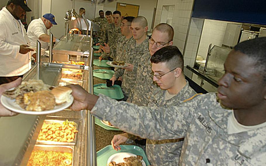 Spc. Doinell Williams, right, of the 52nd Signal Battalion, and other soldiers file through the lunch line Friday shortly after the reopneing of the Black Stallion Inn, the dining facility at Patch Barracks in Stuttgart, Germany.