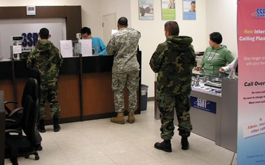 Military customers doing business on Thursday with SSRT shop inside the shopping mall at Osan Air Base, South Korea. The company provides Internet and other service to customers on numerous U.S. military installations in South Korea under contract with the Army and Air Force Exchange Service.