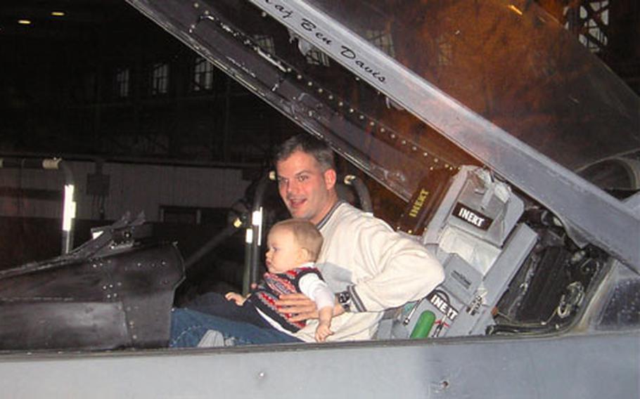 A photo of Tech. Sgt. Michael Knight with his son, Alex, inside a jet was one of those on display during a memorial service June 22, 2006, for Knight and his wife, Laura. Both were killed June 16 in a car crash on an Italian road. Laura Knight was six months pregnant. Alex was also in the car and was injured slightly.