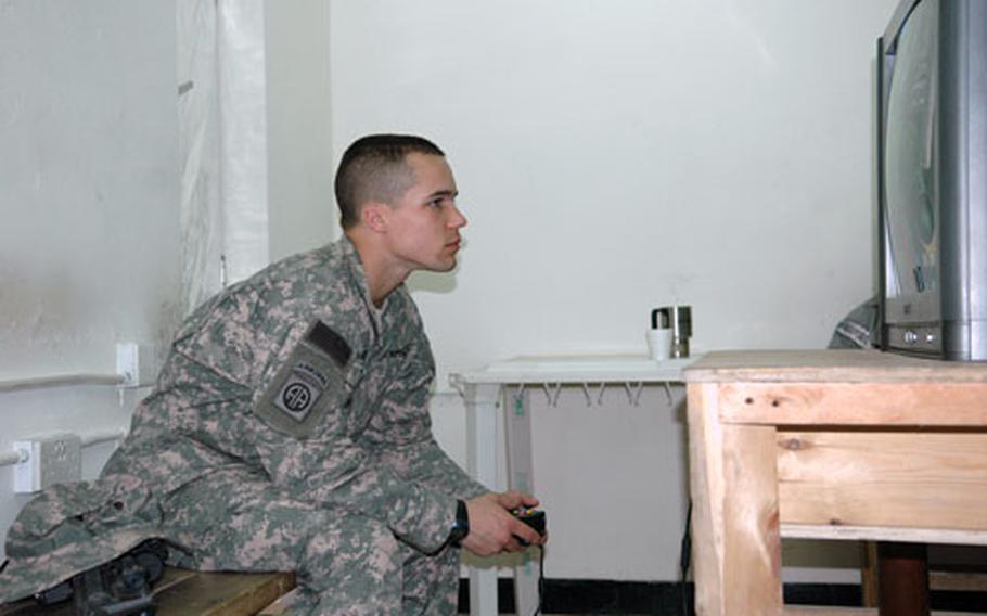 Sgt. Johnathan Hamilton, 22, a forward observer for Company B, 1st Battalion, 504th Parachute Infantry Regiment, takes some time Saturday to play the video game "Far Cry" at Forward Operating Base Loyalty in Baghdad, Iraq.