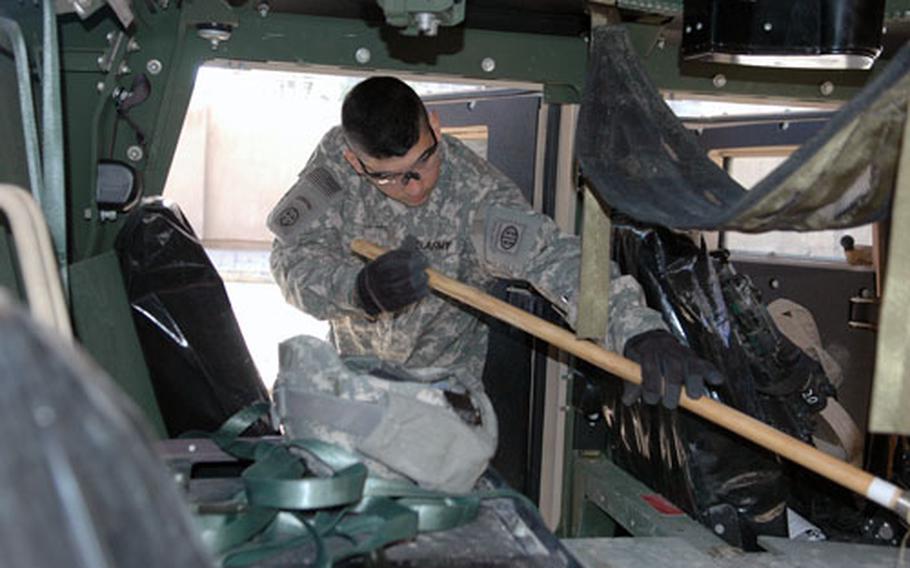 Pvt. Jonathan Duque, 20, of Houston, a member of Company D of the 82nd Airborne Division&#39;s 1st Battalion, 504th Parachute Infantry Regiment, sweeps the Kuwait dust out the inside of his Humvee at Forward Operating Base Loyalty in Baghdad, Iraq. Duque and the rest of the 82nd Airborne battalion, have arrived in Iraq this week as part of the increase of 21,000 troops ordered earlier this month.