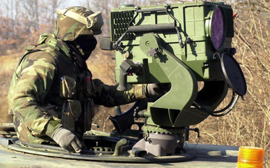 A soldier looks for opposing forces on the battlefield using the Long-Range Advanced Scout Surveillance system at a training area near Yeoncheon on Friday. The battle scenario was part of the 1st Heavy Brigade Combat Team&#39;s Iron Focus exercise, which continues this week.