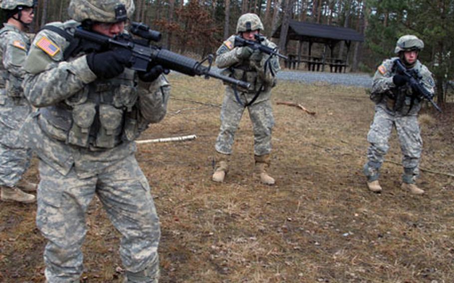 From, left, Pfc. Matt LeBlanc, Pfc. David Thompson, Spc. Nick Orozco and Pfc. Daniel Hudson of Company D, 2nd Battalion, 503rd Infantry Regiment, 173rd Airborne Brigade practice clearing rooms on a floor plan that was mapped out on the ground at Grafenwohr, Germany on Monday. The 173rd, along with several other Europe-based units have received orders to go downrange later this year.