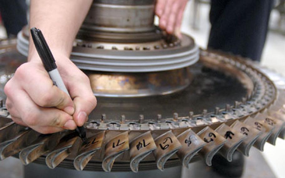 Senior Airman Robert Marcy, a jet engine mechanic assigned to the 52nd Component Maintenance Squadron, marks pieces of a high-pressure turbine rotor before disassembling it for maintenance at Spangdahlem Air Base, Germany, on Thursday. The 52nd&#39;s engine shop was selected as the base’s first attempt at Air Force Smart Operations for the 21st century, also know as AFSO 21.