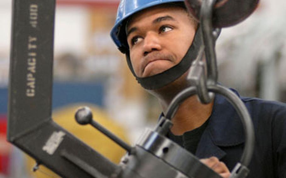 Airman 1st Class Jakori Cox, a jet engine mechanic assigned to the 52nd Component Maintenance Squadron, positions a high-pressure turbine rotor for maintenance at Spangdahlem Air Base, Germany, on Thursday.