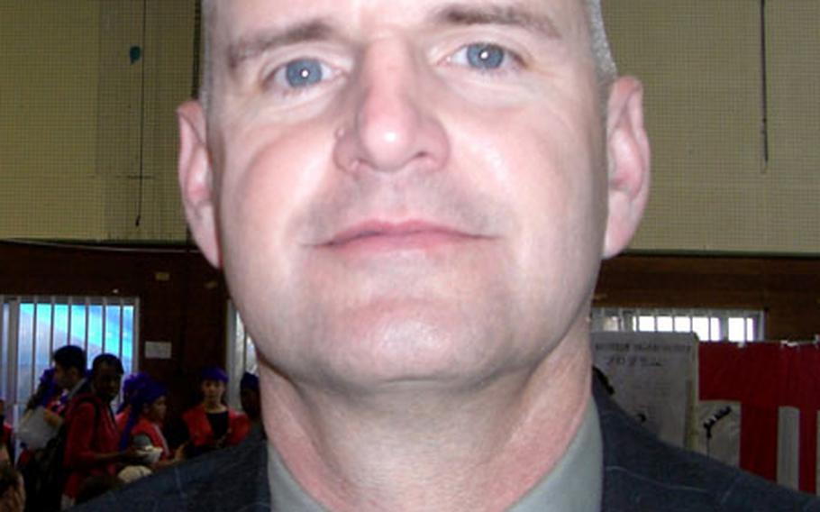 Col. Russell Jones, commander of Camps Foster and Lester, encourages his Marines to volunteer in the Okinawa community.