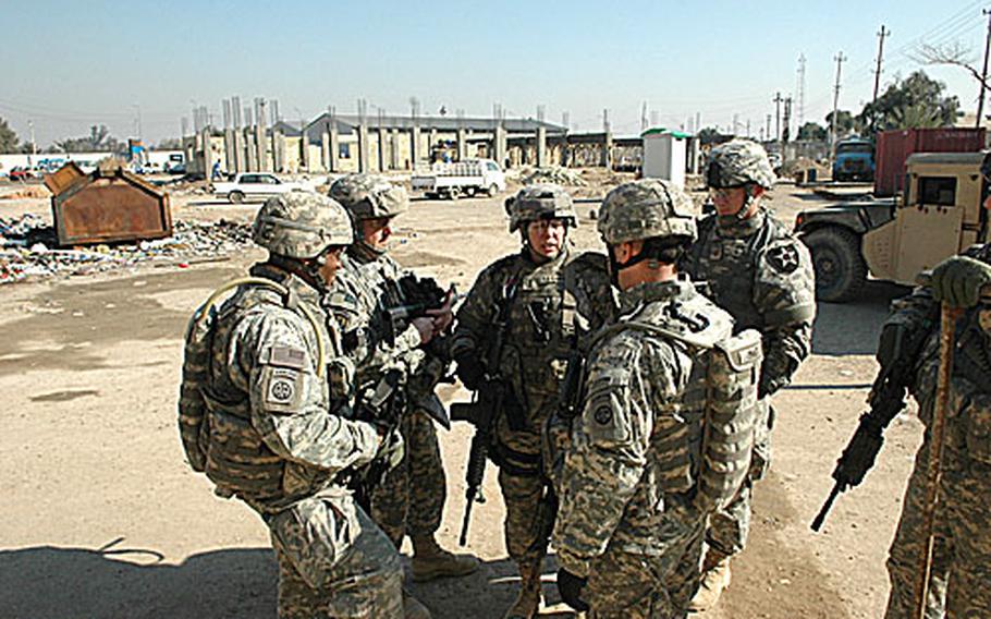 1st Lt. Monique Barnhart (center) briefs other military officials on a Joint Security Station in East Baghdad. From left are: Lt. Col. Carl Alex, commander of the 82nd Airborne Division’s 1st Battalion, 504th Parachute Infantry Regiment; Maj. Gary Morris, the 2nd Brigade Combat Team, 2nd Infantry Division&#39;s officer in charge of force protection; Staff Sgt. Kevin Palmer, Police Transition Team chief from the 240th Military Police Company; and Maj. Mike Pratt, the 1-504th operations officer.