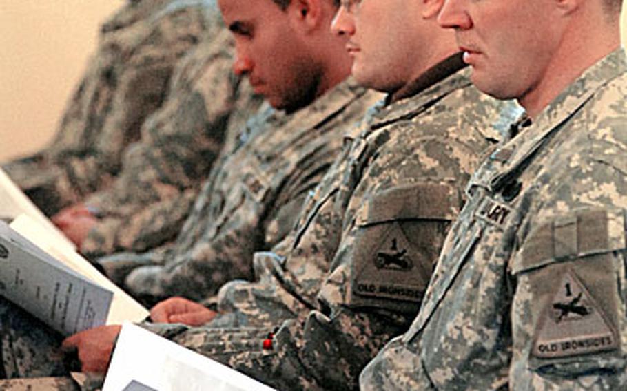 Soldiers of the 1st Armored Division listen to the service records of Sgt. Edward Shaffer and Pfc. David Dietrich at the memorial ceremony in Friedberg, Germany on Wednesday for the two 1st Brigade Combat Team soldiers.