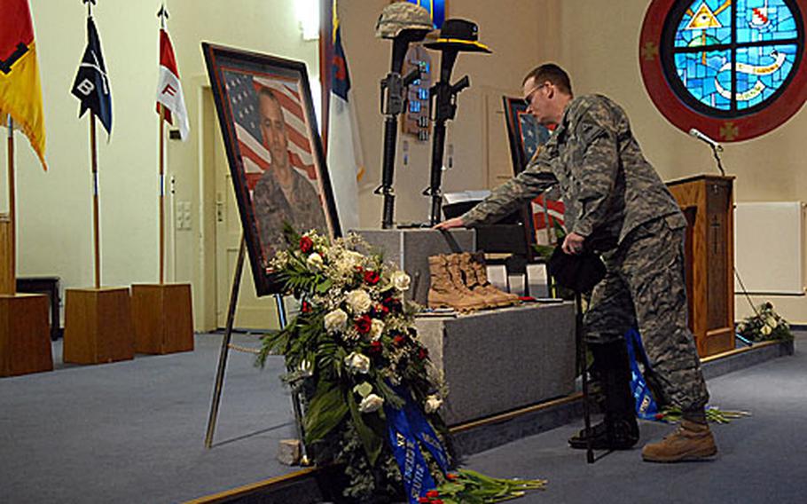 Sgt. James Horton of Company C, 1st Battalion, 36th Infantry Regiment says farewell to Sgt. Edward Shaffer and Pfc. David Dietrich at the memorial ceremony in Friedberg, Germany, for the two 1st Brigade Combat Team soldiers.