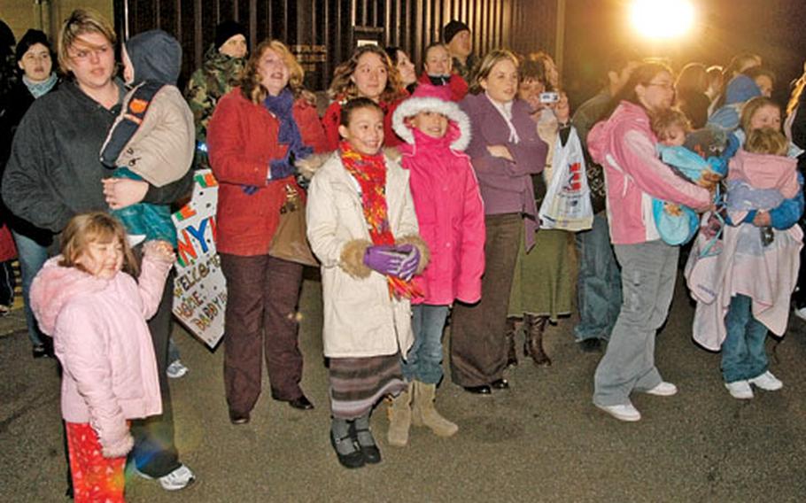 Families and friends wait outside in freezing temperatures Friday morning for the arrival of roughly 300 airmen who returned from a deployment to the Middle East.
