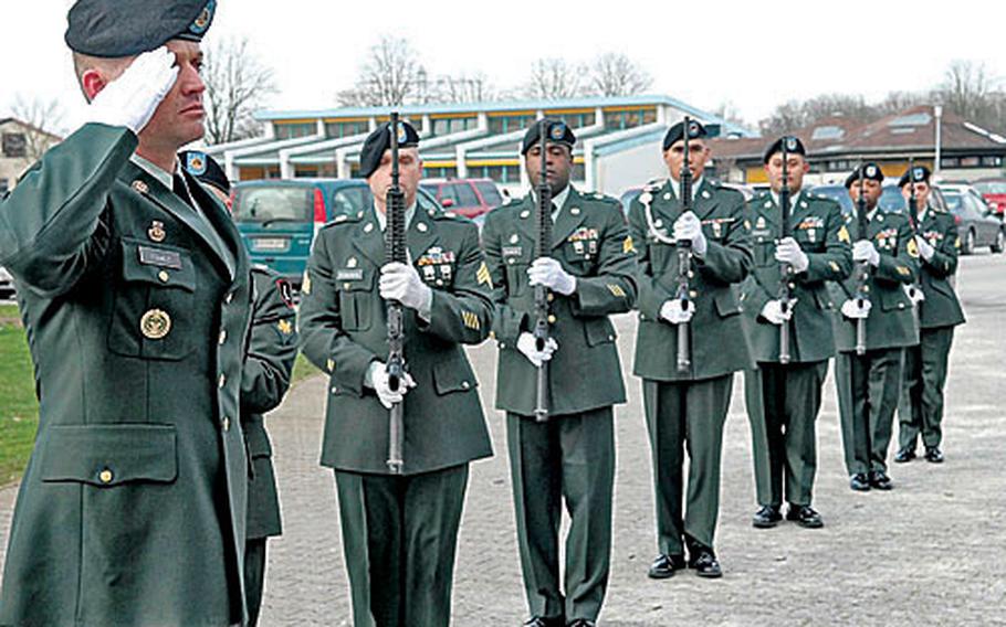 Master Sgt. Eduardo Francis salutes, and the honor guard presents arms as taps is played Friday for Pfc. Valerie Gamboa at Patrick Henry Village chapel in Heidelberg, Germany.