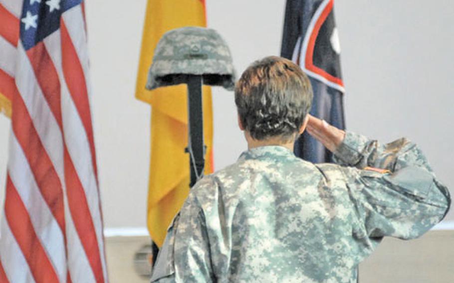 A soldier gives a final salute to Pfc. Valerie Gamboa following the memorial ceremony Friday for the Headquarters and Headquarters Company, 1st Personnel Command soldier at Patrick Henry Village chapel in Heidelberg, Germany.
