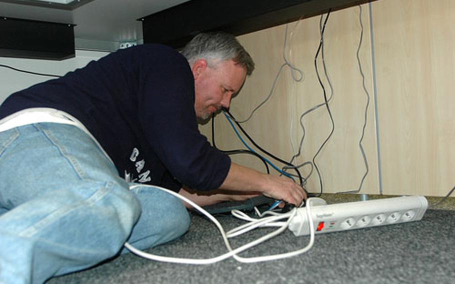 Kevin Canada of U.S. Army Garrison Stuttgart installs a computer on Friday at the Value Added Tax office in the Community Services building at Panzer Casern near Stuttgart, Germany. The building opens on Monday, and many of the services previously found at Patch Barracks will now be located at Panzer.