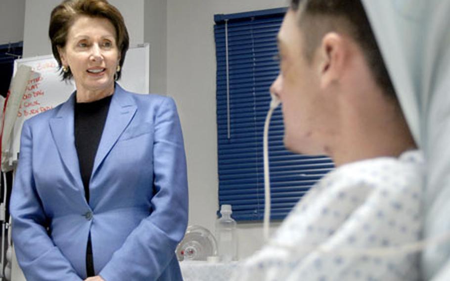 House Speaker Nancy Pelosi, D-Calif., talks Monday with Pfc. Colin Lightfoot, a wounded medic from the 1st Cavalry, in the intensive-care unit at Landstuhl Regional Medical Center, Germany.