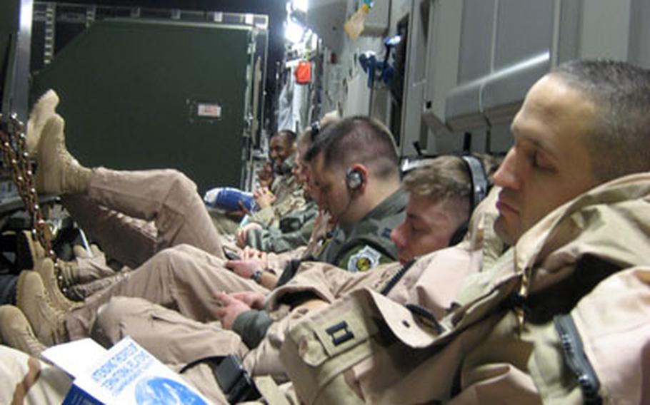 Misawa airmen snooze on the way to Iraq. An advance team of Misawa airmen rode a C-17 cargo plane en route to Balad Air Base. The airmen arrived in theater on Jan. 10, about a week ahead of the 400-some maintainers, pilots and other personnel deployed to Iraq from Misawa in support of the 14th Fighter Squadron.