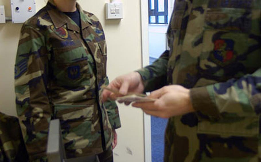 Staff Sgt. Sophia Vargas, left, and Staff Sgt. Scott Baker count up the cash in the base&#39;s gate fund, set aside to help airmen who can&#39;t afford a ride home after a night out on the town.