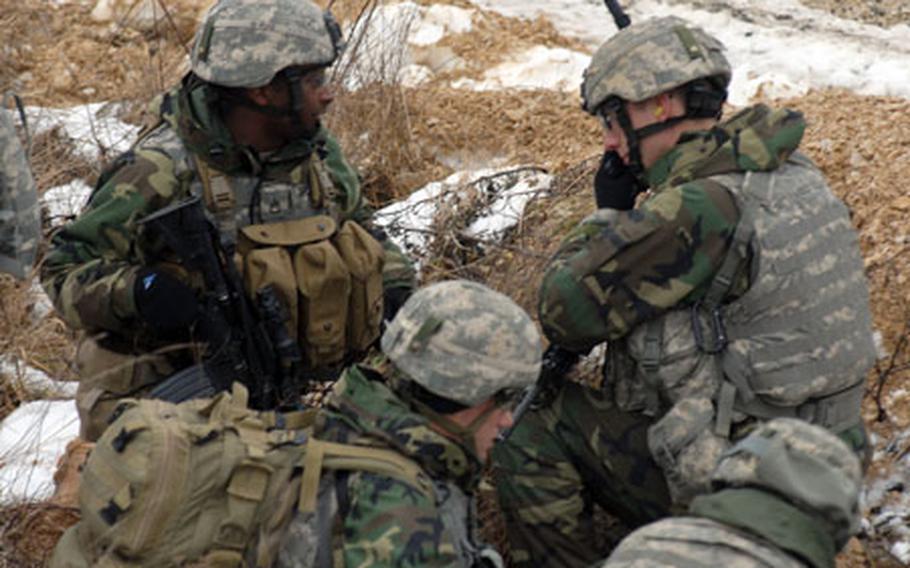 Soldiers from Company D, 2nd Battalion, 503rd Infantry Regiment react to a simulated attack on their convoy by insurgents at Grafenwöhr training range on Tuesday.