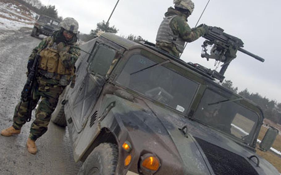 Soldiers from Company D, 2nd Battalion, 503rd Parachute Infantry Regiment react to a simulated attack on their convoy at a training range in Grafenwöhr, Germany, on Tuesday.
