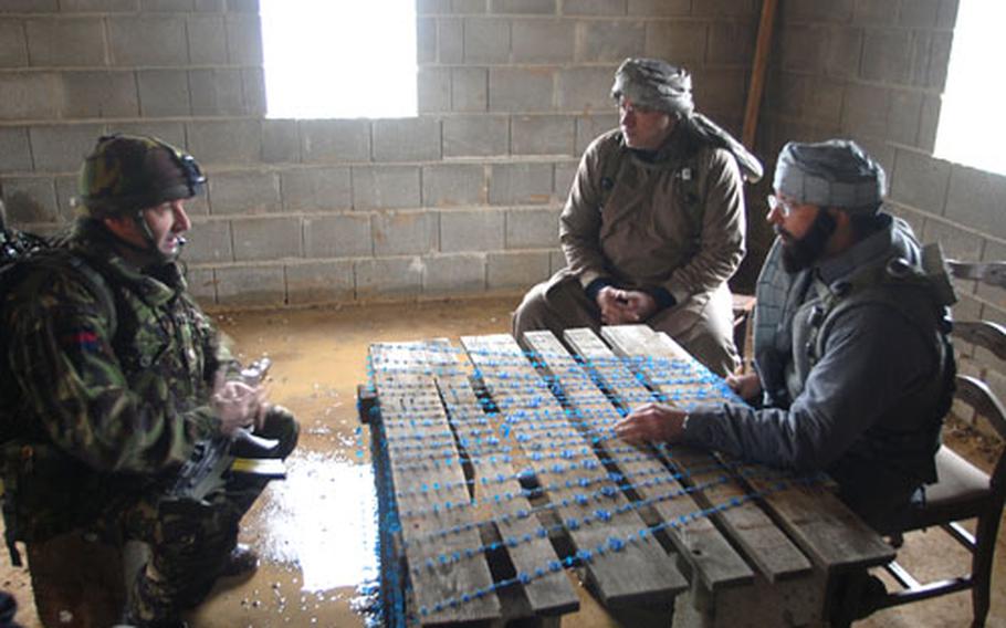 A Grenadier Guard negotiates with role players acting as Afghan town officials at Hohenfels, Germany, on Wednesday.