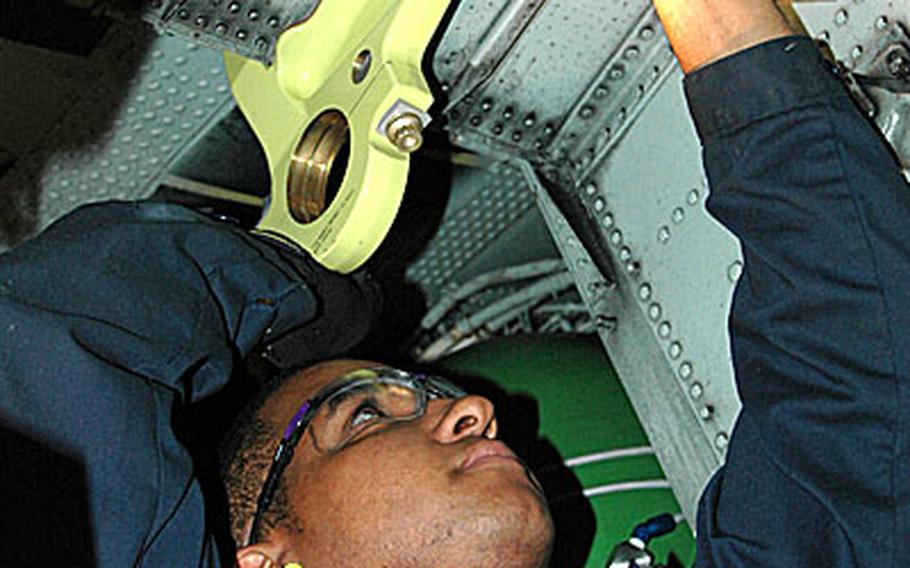 Airman 1st Class Tyrone Spencer of the 374th Maintenance Squadron replaces a trunion that holds up the nose gear of an MC-130P during an Isochronal Inspection at Yokota Air Base, Japan. Utilizing Air Force Smart Operations 21 practices, the squadron was able to reduce the amount of work hours required to complete this inspection.