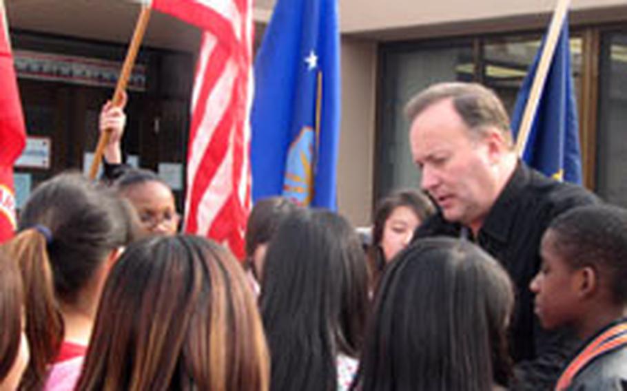 James Clark prepares his sixth grade class for a morning posting of the colors at Osan American Elementary School.