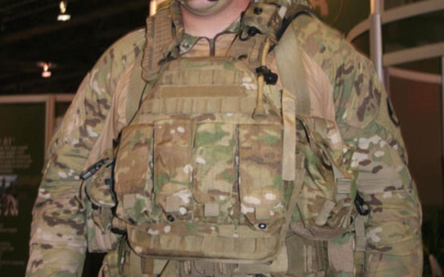 Sgt. Josh Deveraux, 24, of the Natick Soldier Center, shows the Army's new Future Force Warrior system, which features a new type of body armor that is slated to be fielded in fiscal 2010 or 2012.