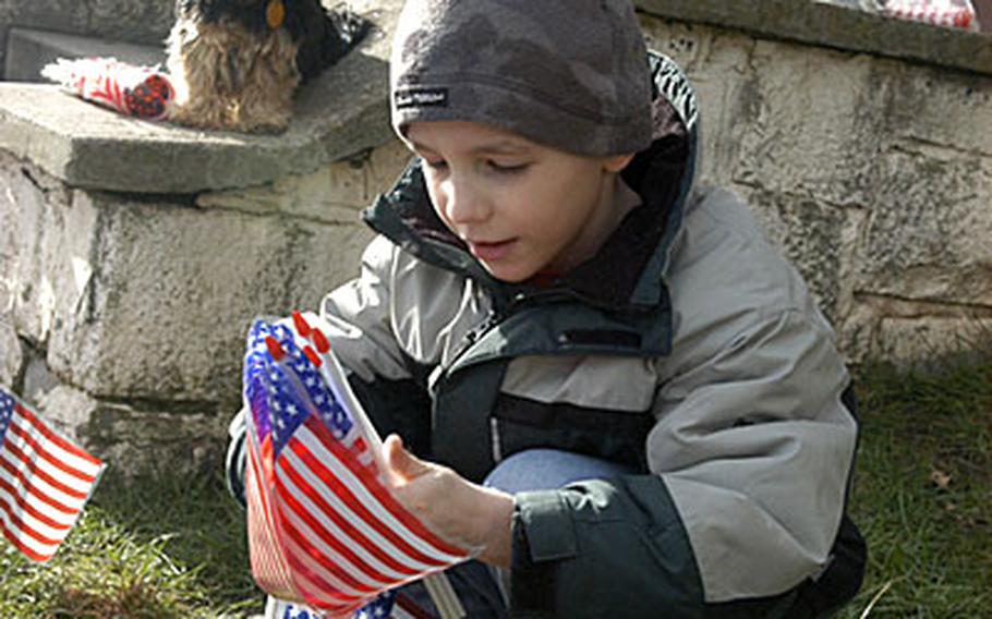 Eight-year-old Cory Schreiber Jr. helps place flags to greet his dad, Sgt. Cory Schreiber, and the other soldiers of Company A, 1st Battalion, 6th Infantry at Smith Barracks in Baumholder, Germany, on Friday. Unlike the rest of the Baumholder-based 2nd Brigade of the 1st Armored Division, the approximately 150 company soldiers are still in Iraq and headed home any day now. They deployed with and were attached to the 1st AD's 1st Brigade, out of Friedberg, Germany, since January 2006.