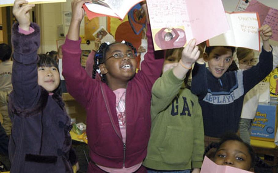 Students from Jennifer Sharp’s 2nd-grade class, Taegu American School, South Korea, display the Valentine's Day cards they made for “their soldier,” Pvt. Victor Girau, who is serving in Iraq.