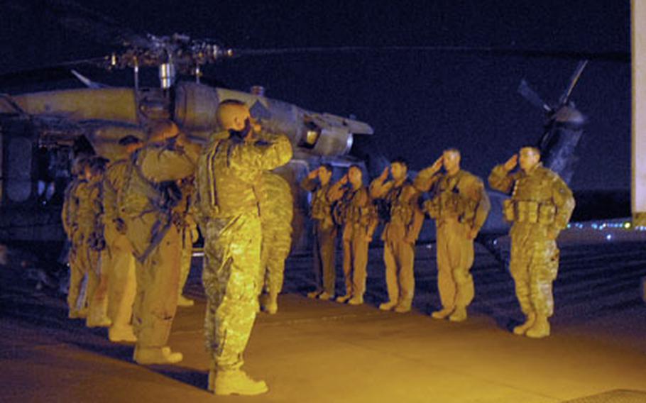 Two Black Hawk crews from the 25th Combat Aviation Brigade, 25th Infantry Division, salute the fallen soldiers they transported to Balad on Feb. 9.